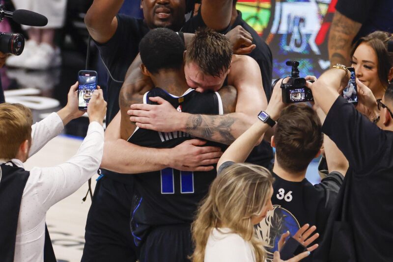 Luka Doncic (c-d), base esloveno de los Mavericks de Dallas, fue registrado este sábado, 18 de mayo, al abrazar a su compañero Kyrie Irving, después de derrotar a los Thunder de Oklahoma City en el sexto y definitivo partido de esta serie semifinal de la Conferencia Oeste de la NBA, en el coliseo American Airlines Center de Dallas (Texas, EE.UU.). EFE/Adam Davis