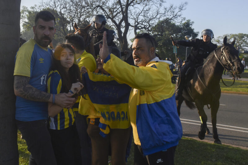 Hinchas de Rosario Central buscan protegerse de los enfrentamientos entre fanáticos y policías antes del partido de Copa Libertadores jugado a puerta cerrada que Atlético Mineiro ganó por 0-1. EFE/ Franco Trovato Fuocoo