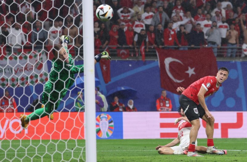 Leipzig (Germany), 02/07/2024.- Turkey goalkeeper Mert Gunok (L) saves a shot from Christoph Baumgartner of Austria (R) during the UEFA EURO 2024 Round of 16 soccer match between Austria and Turkey, in Leipzig, Germany, 02 July 2024. (Alemania, Turquía) EFE/EPA/CHRISTOPHER NEUNDORF
